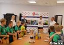 uśmiechnięci chłopcy przy stołach